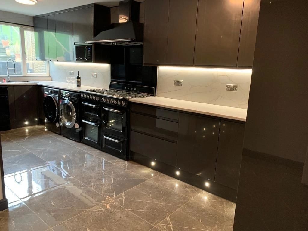 Completed modern kitchen with black cabinets — carpentry and fitting West London