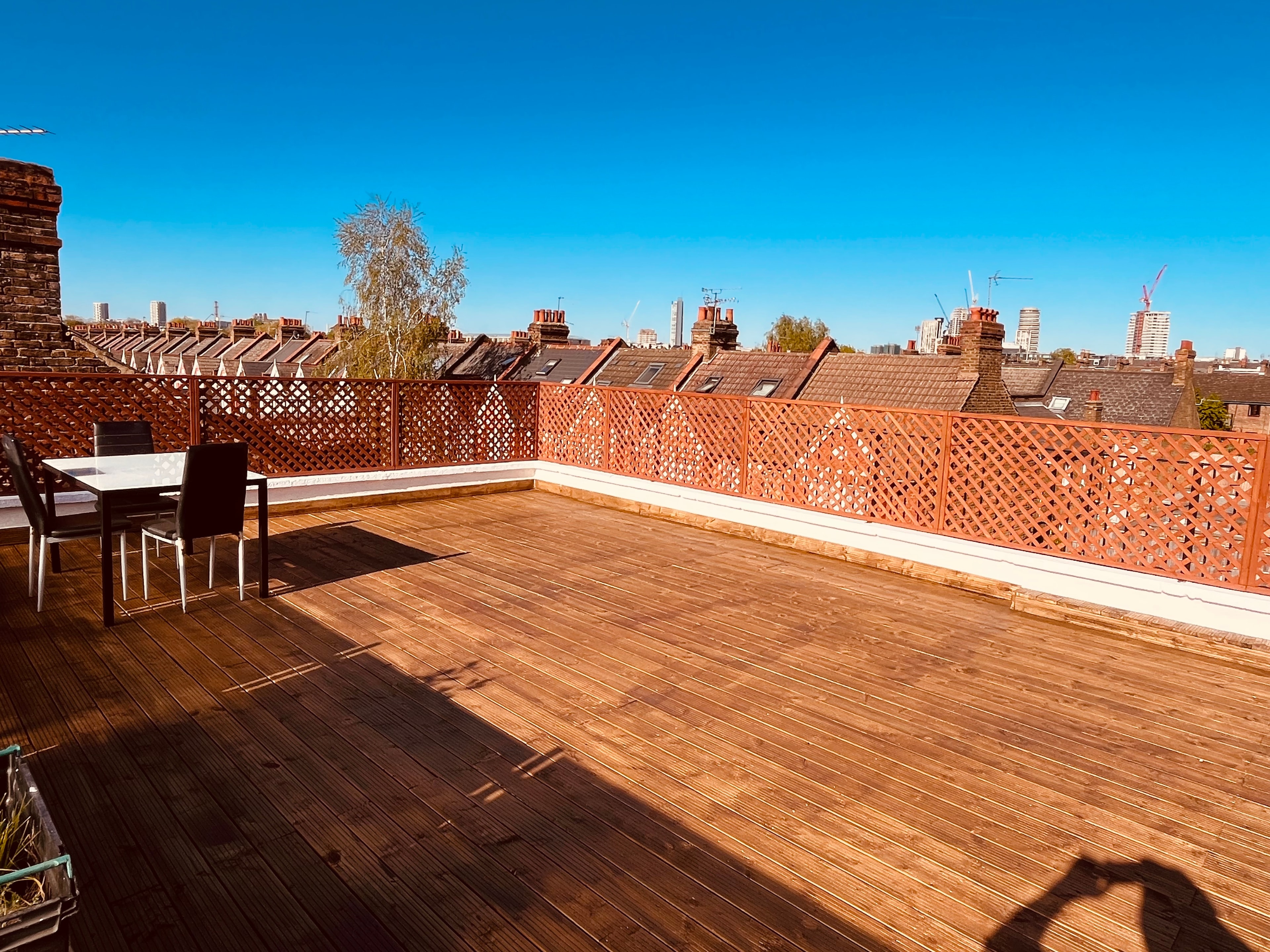 Rooftop decking with timber balustrade — West London