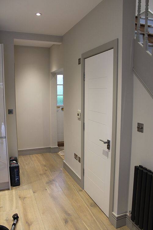 Hallway renovation with white doors and wood flooring — West London