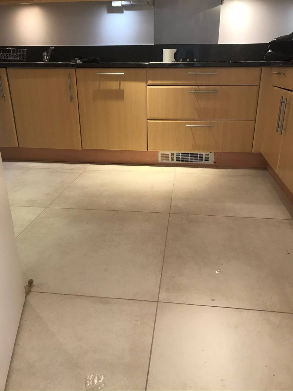 Large format floor tiling in kitchen — West London